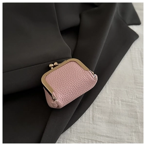 Close-up of pink lychee leather mini bag with vintage gold metal ball clasp
