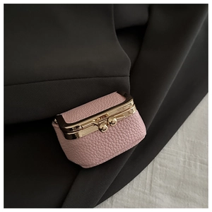 Macro shot of pink lychee leather coin purse with vintage gold metal clasp detail