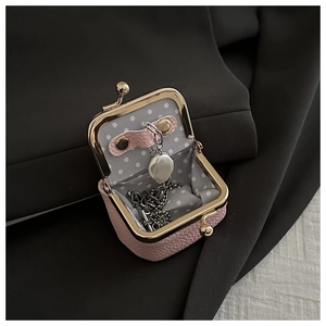 Pink lychee grain leather mini jewelry bag with pearl necklace and gold metal clasp