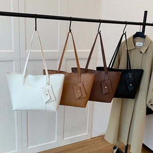 Set of minimalist tote bags with mini pouches in white, khaki, brown, and black