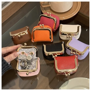 Macro view of mini leather jewelry box interior with necklace hooks and ring slots