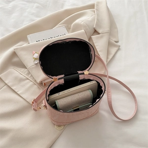 Pink pebbled leather crossbody bag showing internal space for phone and card holder
