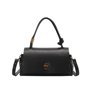 Chic black textured crossbody bag with vintage gold buckle and top handle detail