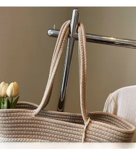 Detailed macro shot showing the thickened woven shoulder strap of a straw tote bag