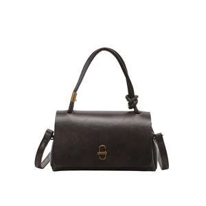 Retro square crossbody bag in dark leather with gold twist lock and knotted handle detail