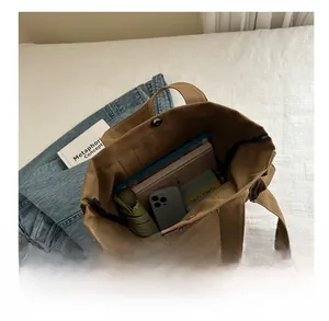 Top view of large brown canvas tote bag showing spacious interior with daily essentials
