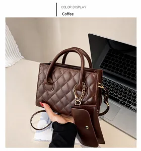 Detail view of coffee brown quilted tote bag with chain pouch on a minimalist desk
