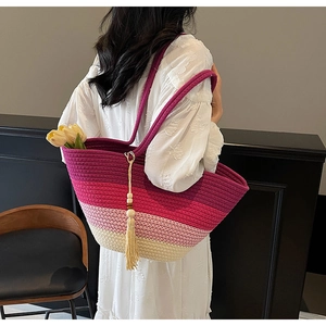 Detail of hand-woven striped tote bag with colorful tassels and premium texture