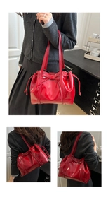 Detailed views of a red glossy patent leather underarm bag with a decorative bow knot