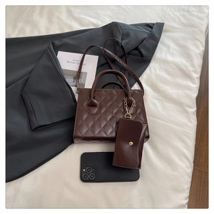 Detailed view of brown quilted handbag with matching small coin pouch and gold chain