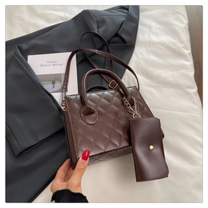 Detail of dark brown quilted tote bag with matching mini pouch and gold chain hardware