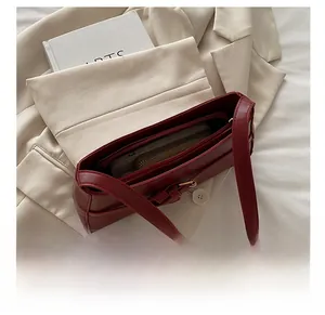 Spacious interior of dark red underarm bag showing room for phone and wallet