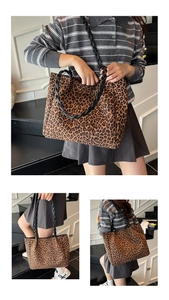 Close-up of leopard print tote bag with black woven leather handles and textured suede fabric