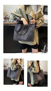 Leopard print tote bag with black woven straps shown in casual street style setting