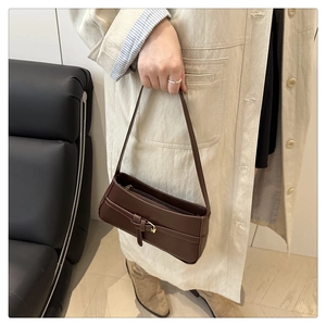 Deep brown leather underarm bag featuring sleek golden buckle and rich glossy finish