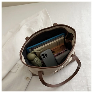 Top view of large capacity PU tote bag showing spacious interior with daily essentials