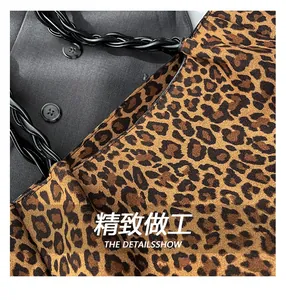 Close-up of leopard print tote bag fabric with black woven rope handle detail