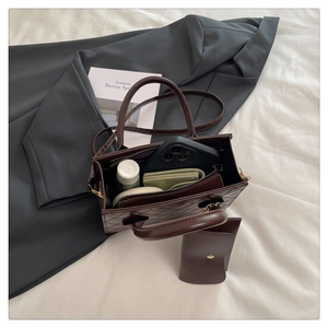 Internal view of brown quilted crossbody bag showing spacious storage for daily essentials