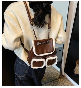 Back view of model wearing a vintage dark brown leather backpack with white faux fur trim