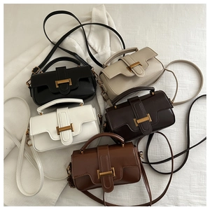 Flat lay of multiple stylish square shoulder bags in diverse seasonal colors with gold clasps