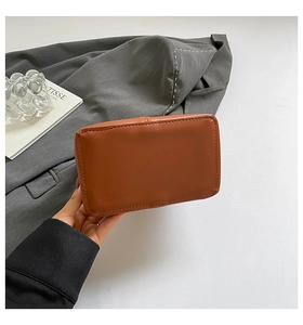 Close-up of brown leather bag bottom with fine stitching and rectangular structure