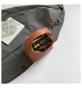Detail of caramel leather bag interior showing large capacity for makeup and accessories