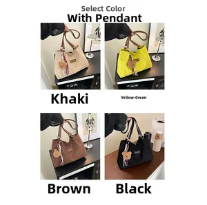Detail of corduroy tote bags in khaki, green, brown, and black with cute bear charms