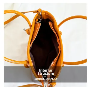 Top view of the bright orange tote bag showing the spacious internal structure and zipper