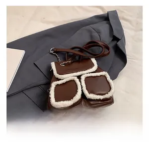 Detail showing deep brown leather backpack with fuzzy faux shearling trim and dual pockets