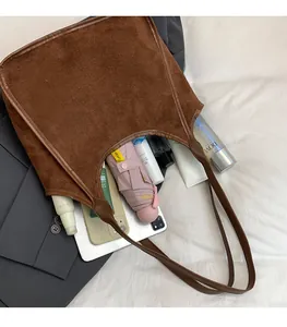 Top view of spacious brown suede bucket bag showing large interior capacity for daily items