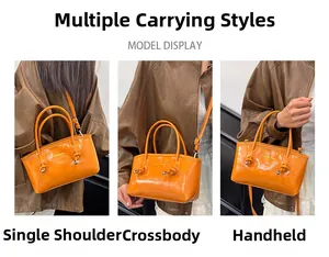 Detail view of mini orange glossy leather handbag shown in handbag, shoulder, and crossbody styles