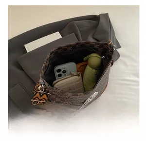 Internal view of brown jacquard bucket bag showing large capacity for phone and wallet