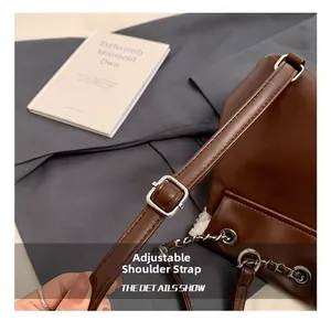Detail of adjustable leather strap with silver metal buckle on autumn plush handbag