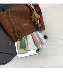 Detail of brown quilted corduroy tote bag showing large capacity for laptop and cosmetics