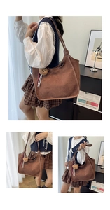 Detailed view of a large brown suede tote bag featuring a cute teddy bear charm pendant