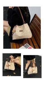 Detail of beige quilted tote bag with brown leather strap and cute bear charm in autumn