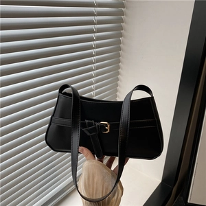 Minimalist black baguette shoulder bag with gold metal buckle and leather strap
