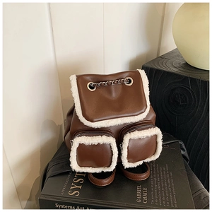 Detail of vintage brown faux leather and white shearling backpack with silver chain