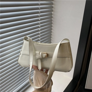 Minimalist cream white baguette shoulder bag with gold buckle hardware and smooth leather