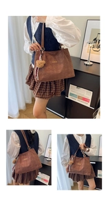 Detail of brown quilted tote bag with Creative Cat logo and cute bear charm pendant