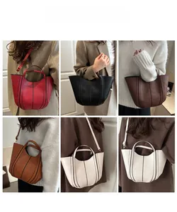 Collage of leather bucket bags in five colors showing hand-carry and crossbody styling options