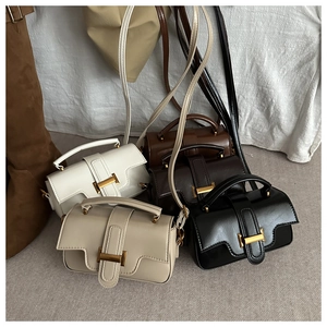 Detail view of four minimalist shoulder bags with signature H-shaped gold metal buckles