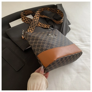 Detail of crossbody bag featuring M letter jacquard pattern and wide geometric strap