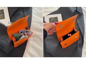 Detail view of mini orange leather crossbody bag showing interior capacity and magnetic clasp