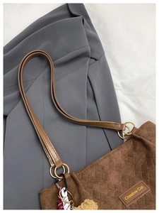 Detail of dark brown corduroy tote bag with quilted diamond pattern and Creative Cat logo