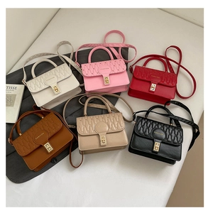 Detailed display of assorted colors of quilted square handbags with metal turn-lock closures
