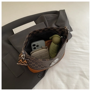Internal view of spacious vintage brown monogram crossbody bag with wide webbed strap
