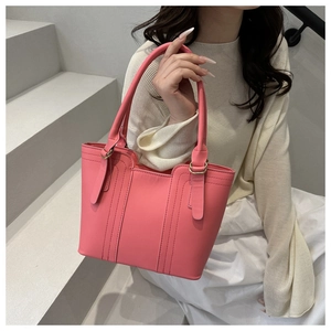 Detail of pink leather handbag with vertical stitching on stairs in professional lifestyle shot