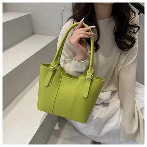 Fashionable bright green faux leather tote bag with elegant vertical stitching and gold rings