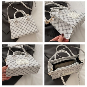 Detail of white monogram handbag with G logo, dual handles and detachable shoulder strap